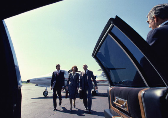 group of people walking up to limousine door